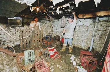 Flood-damaged basement with stone walls